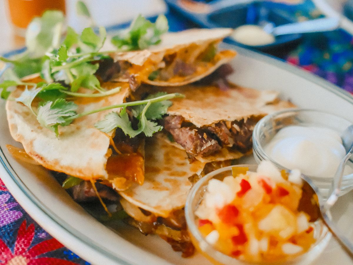 Folded loaded quesadilla with shredded beef, half-moon, toasted golden